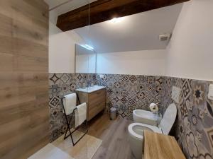 a bathroom with a toilet and a sink at Bastione Apartment in Riva del Garda
