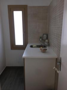 a small kitchen with a sink and a window at Hotel Roc de St Miquel & Apartment in Soldeu