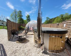 a backyard with a gazebo and a grill and a playground at Fichtel-Bubble HotTub optional zubuchbar in Hohenberg an der Eger