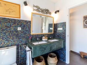 a bathroom with two sinks and a mirror and a toilet at Casa Ishtar in Nigüelas +36 photos