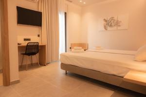Ένα ή περισσότερα κρεβάτια σε δωμάτιο στο Nomad Hotel Paralia