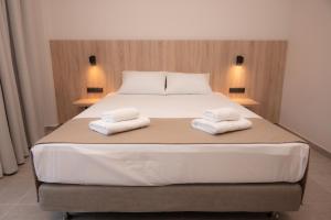 Ένα ή περισσότερα κρεβάτια σε δωμάτιο στο Nomad Hotel Paralia