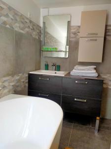 a bathroom with a sink and a mirror at Maison confortable à Lens proche du centre et du stade in Lens +21 photos