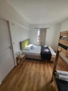 a bedroom with a bed and a wooden floor at What Else Guest House - Fatima in Fátima