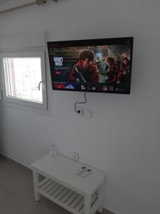 a flat screen tv hanging on a wall at Villa Giotis Suite in Skala Sotiros