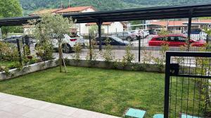 a yard with a fence and a parking lot with cars at Apartment Lake Garda in Garda