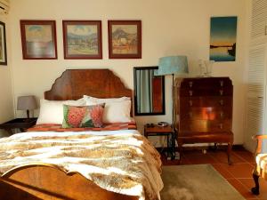 a bedroom with a large bed and a dresser at Alberton Africa Away in Alberton