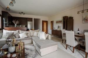 a living room with a white couch and a table at Luxury Sweet Home in Agria