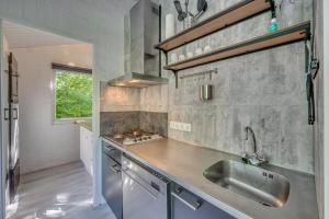 a kitchen with a sink and a counter top at Groenpark Simpelveld - Castra 33 in Simpelveld