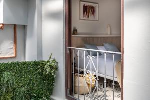 a balcony with a bed in a room at Líbere Málaga la Merced in Málaga