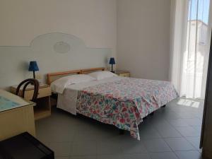 Postel nebo postele na pokoji v ubytování Hotel Villa Cecilia