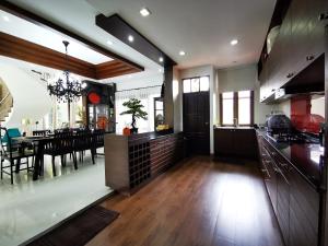 a large kitchen and dining room with a dining table at YiZen Boutique Phutara 5 Bedroom Villa in Nong Prue