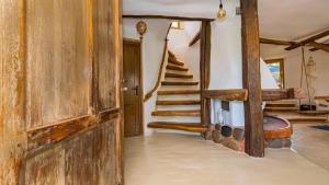 ein Wohnzimmer mit einer Wendeltreppe in einem Haus in der Unterkunft Clay House Banya in Banya