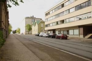 a street with cars parked on the side of a building at City Center 2-rooms apartment in Vaasa