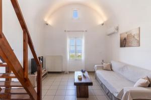 a living room with a couch and a table at Ampelos Executive Houses in Pyrgos