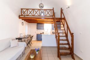 a living room with a loft bed and a kitchen at Ampelos Executive Houses in Pyrgos