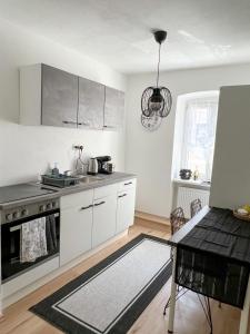 a kitchen with white cabinets and a table in it at Apartment in Gmunden in Gmunden