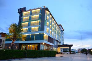 a tall building with lights on in a city at 42C The Chic Hotel in Nakhon Sawan