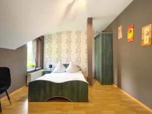 a bedroom with a bed with white sheets and a window at Brydar with Sauna, Swimming Pool and Jacuzzi in Mielno