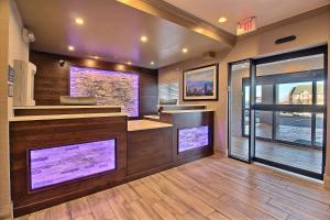 a restaurant with a counter with two large windows at Best Western Greeley in Greeley