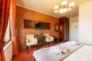 Posteľ alebo postele v izbe v ubytovaní Hotel Plumlov