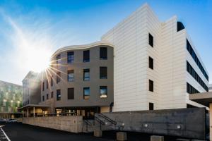 a white building with the sun in the sky at Livensa Living Studios San Sebastián in San Sebastián