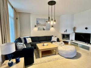 a living room with a couch and a table at Private seaview villa in BlackSeaRama - 1st line in Balchik