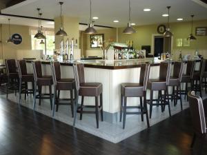 a bar in a restaurant with a bunch of chairs at AGH Canet in Canet de Berenguer