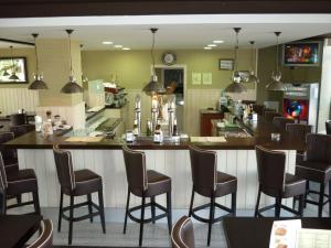 a bar in a restaurant with chairs and a counter at AGH Canet in Canet de Berenguer
