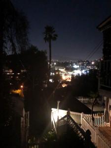 a view of a city at night with a palm tree at VacaStay on Scandia Way in Los Angeles