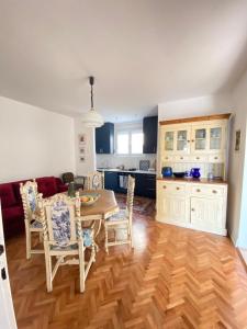 a kitchen and living room with a table and chairs at Lovely and peaceful vintage apartment near beach in Tivat