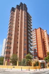two tall buildings in a city with a street at Don Gregorio-Fincas Benidorm in Benidorm