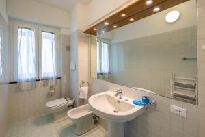 a white bathroom with a sink and a toilet at Le Casasse "Paradiso" in Varigotti +36 photos