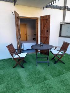 a room with a table and two chairs and a bed at Hostal Casa Juan in Castejón de Sos