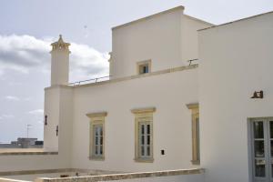 a white building with a lighthouse on top of it at Nohasi Palace in Noha