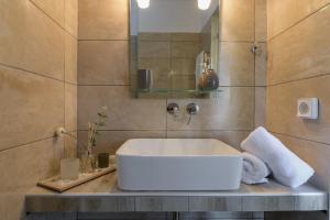 a bathroom with a white sink and a mirror at Casa De' Fiori Kefalonia in Skala Kefalonias +70 photos