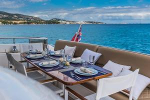 a table on the back of a boat on the water at Euphoria Luxury Yacht including Full Day Charter for up to12 guests in Parkstone