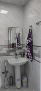 a bathroom with a sink and a mirror at Brick House in Lahıc +32 photos