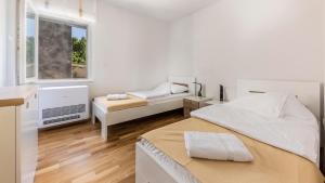 Postel nebo postele na pokoji v ubytování Villa Ancora AP 01