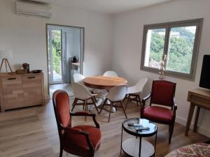 a living room with a table and chairs at La Vallicella in Farinole