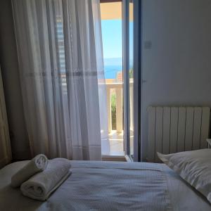 a bedroom with a bed with towels on it at Villa Mila in Bol