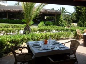 a table with plates and glasses on top of it at AGH Canet in Canet de Berenguer