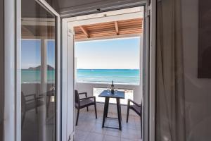 a room with a table and a view of the ocean at Blue Horizon Studios in Laganas