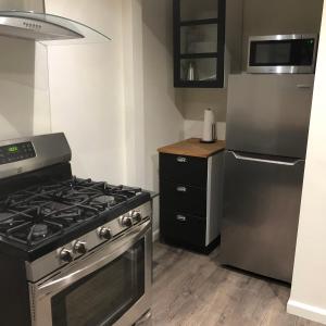 a kitchen with a stove and a refrigerator at VacaStay on Scandia Way in Los Angeles