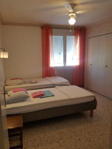a bedroom with two beds and a window at City Break in Narbonne