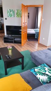 a living room with a couch and a coffee table at Pannonia Apartman in Esztergom
