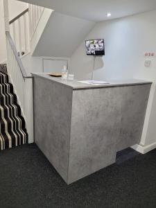 a concrete counter in a room with a staircase at OYO Victoria Apartments in Middlesbrough