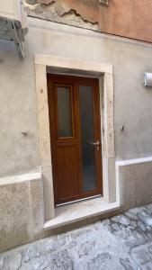 a wooden door on the side of a building at Morski Val in Piran