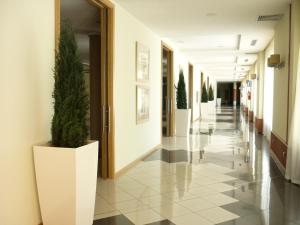 a corridor of a hospital hallway with potted plants at AGH Canet in Canet de Berenguer