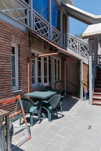 a patio with a table and chairs in front of a brick building at Mariami apartment old tbilisi in Tbilisi City
